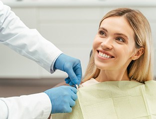 A smiling young woman who just received tooth-colored fillings