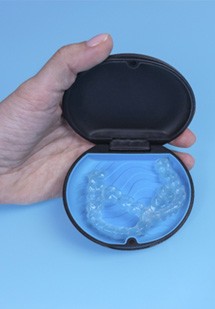 Invisalign aligners in a blue case