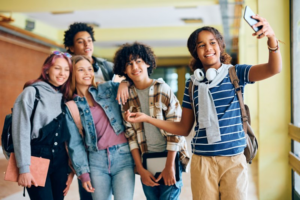 Group of teens taking a selfie inside school